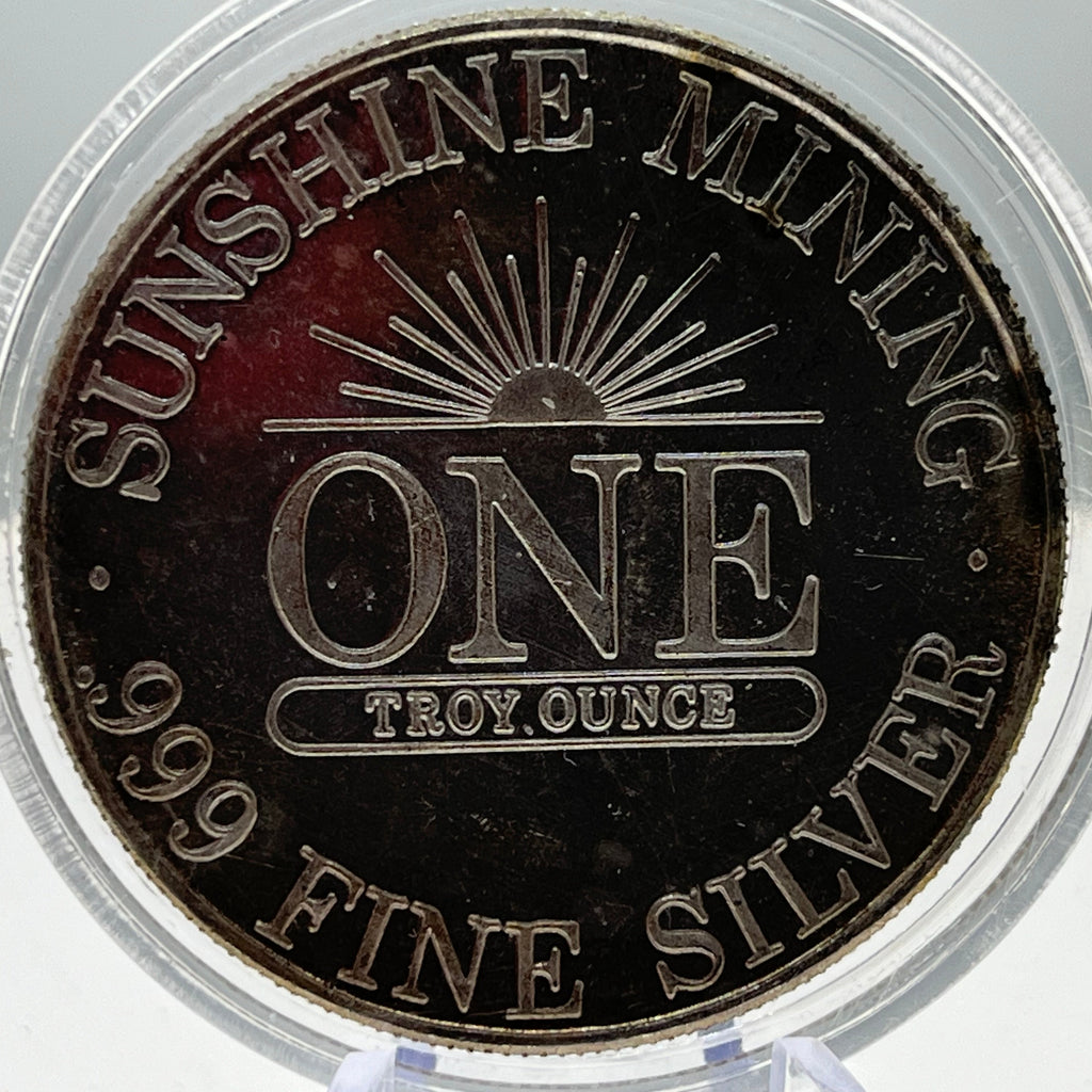 Silver coin with 'Sunshine Mining' branding and specifications on a clear holder.