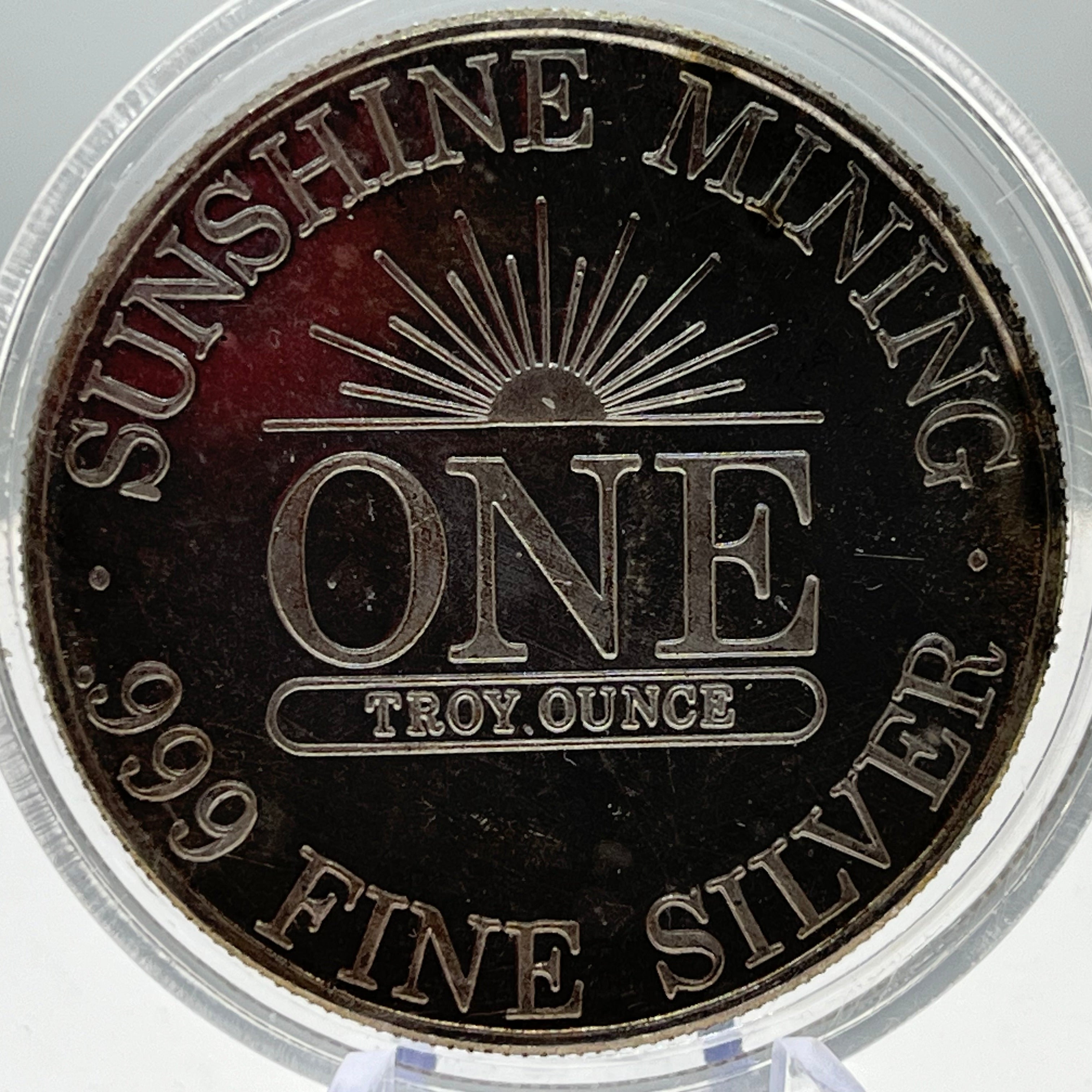 Silver coin with 'Sunshine Mining' branding and specifications on a clear holder.