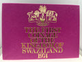 Purple book with gold text and emblem, titled 'The First Coinage of the Kingdom of Swaziland 1974'.