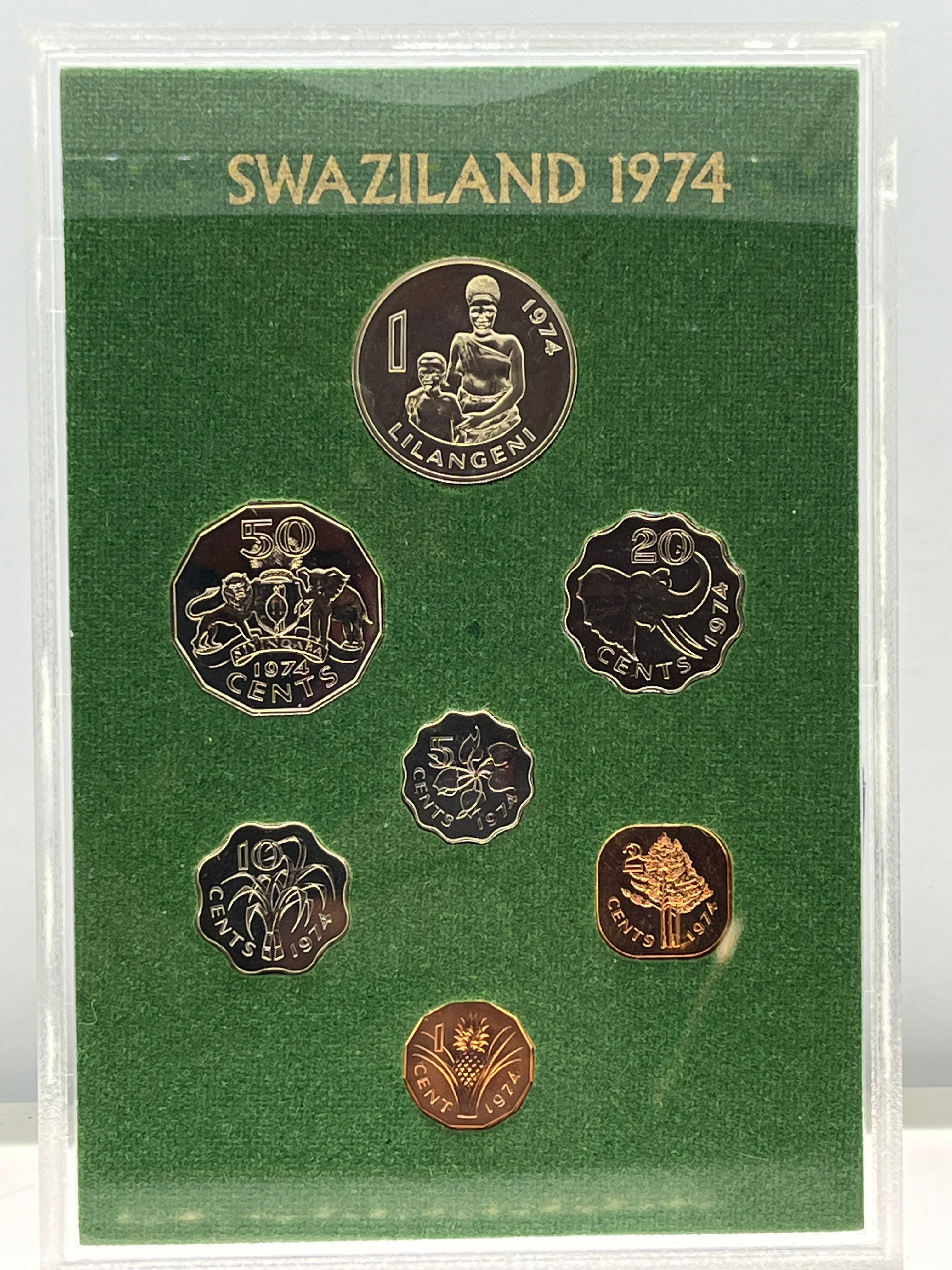 Set of Swaziland coins from 1974 in a green holder with gold and bronze coins.