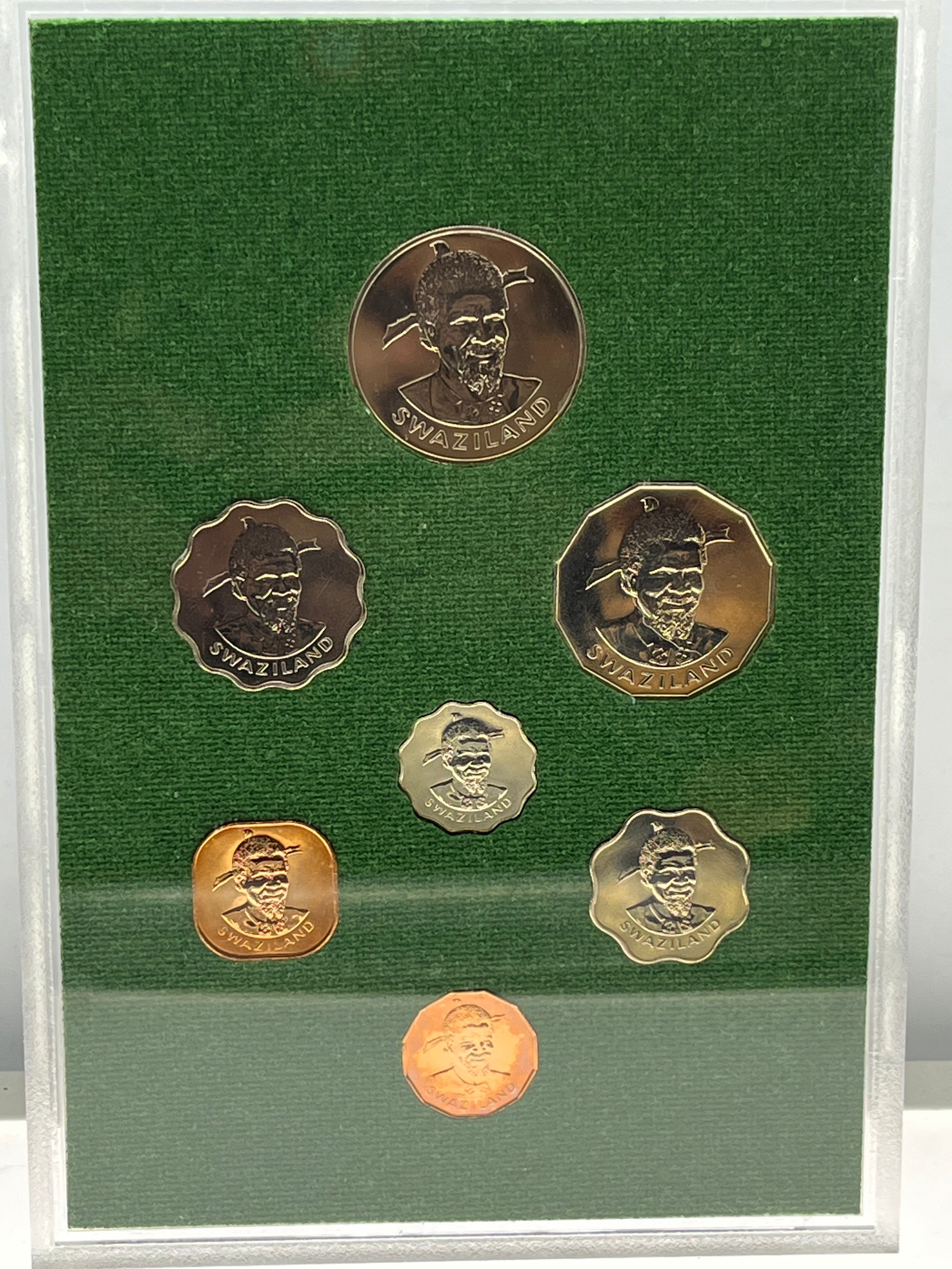 Set of six coins with portraits on a green background