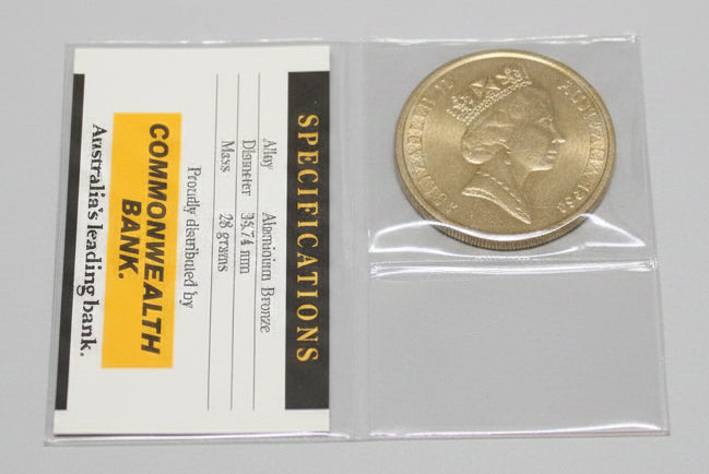 Coin in a protective case with a Commonwealth Bank of Australia label on a dark background