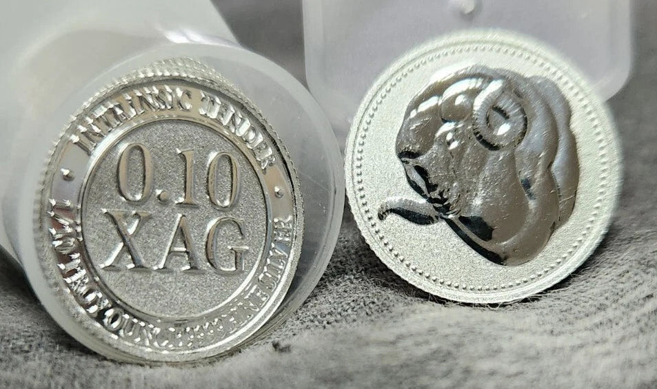 Two silver bullion round coins with '0.10 XAG' on one side and a bull head design on the other both with a textured surface.