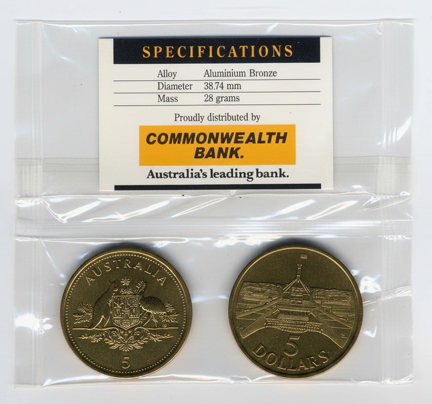 Gold coin in packaging with Commonwealth Bank label on a white background